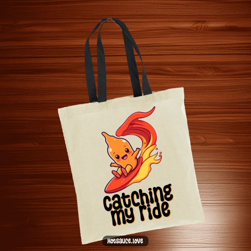 Funny tote bag showcasing a hot sauce character with simple eyes joyfully surfing down a fiery red wave.